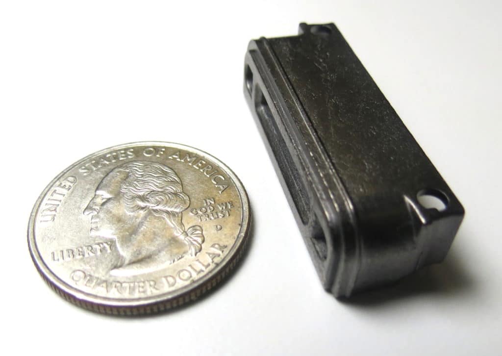 Mini zinc die casting that goes into a handheld bar code scanner.